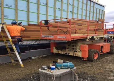 Installing wood siding at Back of House