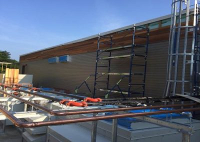 Cement siding and wood siding at Café mechanical yard