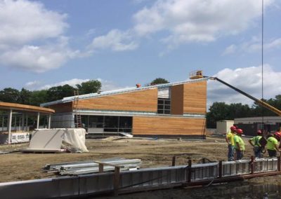 Hoisting metal roof panels to Studio C