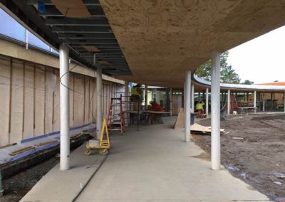 Plywood backing at curved walkway ceiling